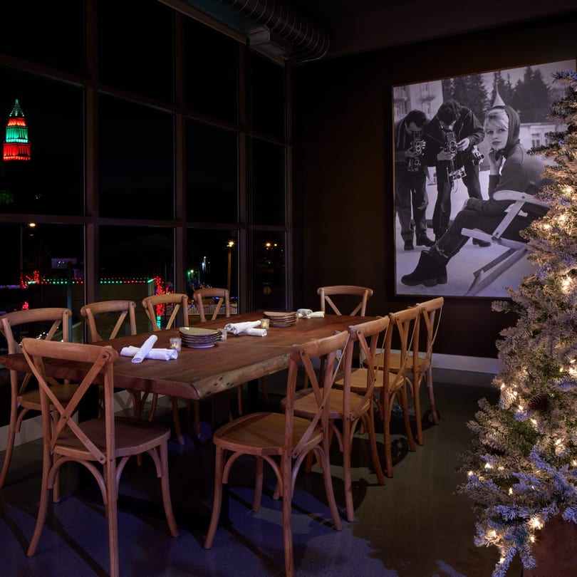 A private dining room at Havana 151 with a long wooden table, chairs, and a large window.