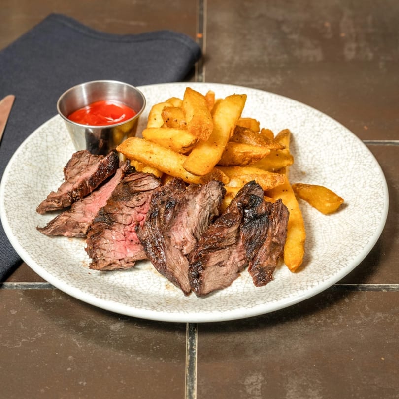 Havana 151's grilled skirt steak, sliced and served with golden fries and ketchup.